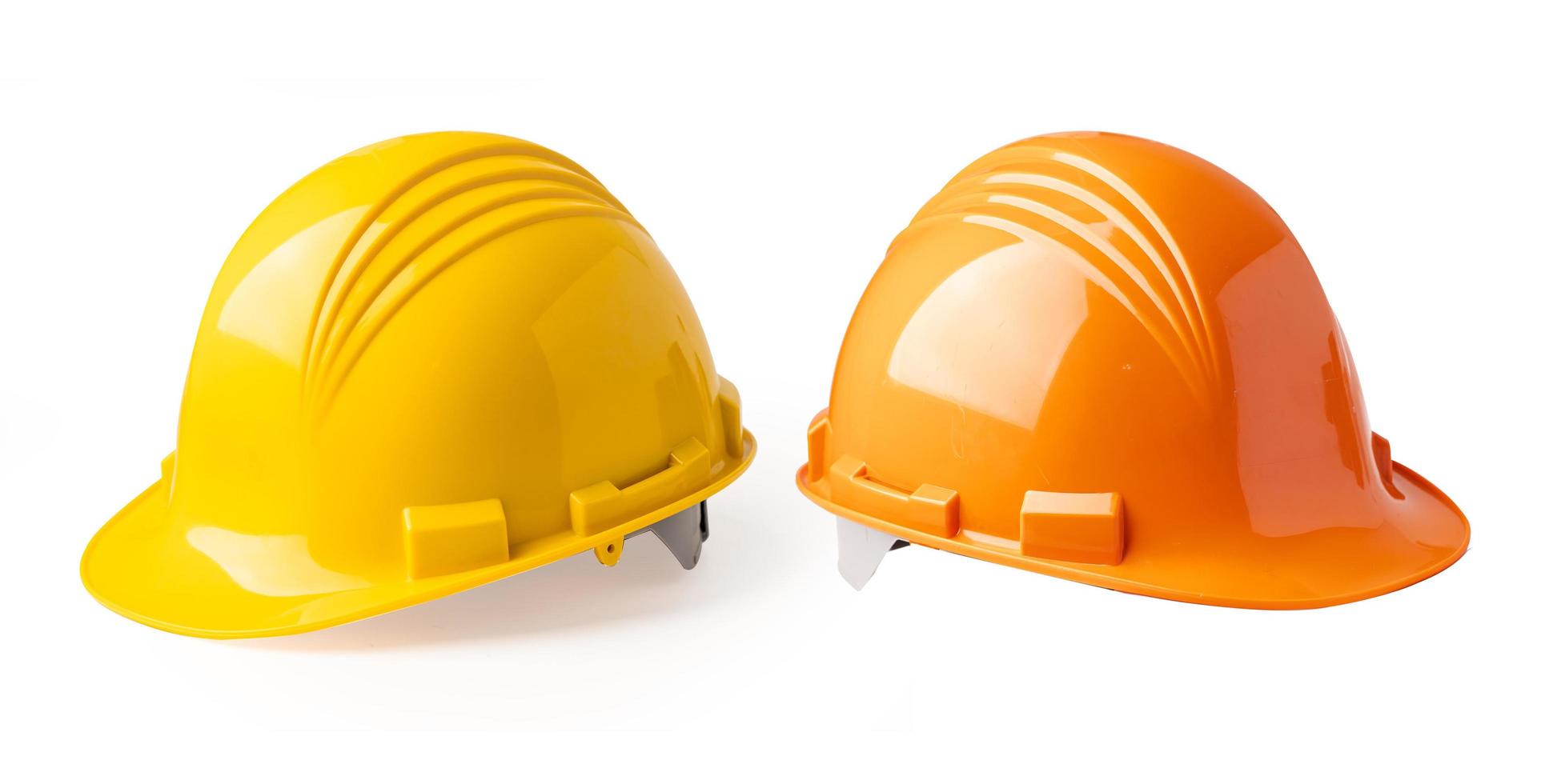 Yellow and Orange color construction helmet isolated on white background photo