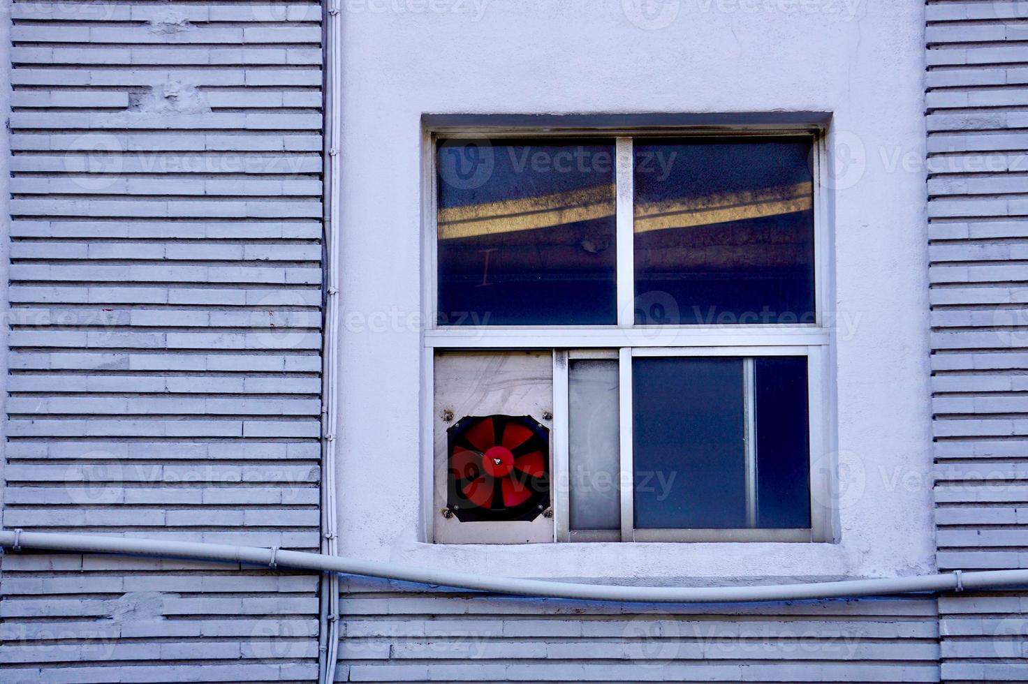 window on the gray facade of the house photo