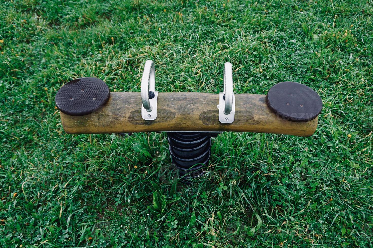 old wooden seesaw in the playground photo