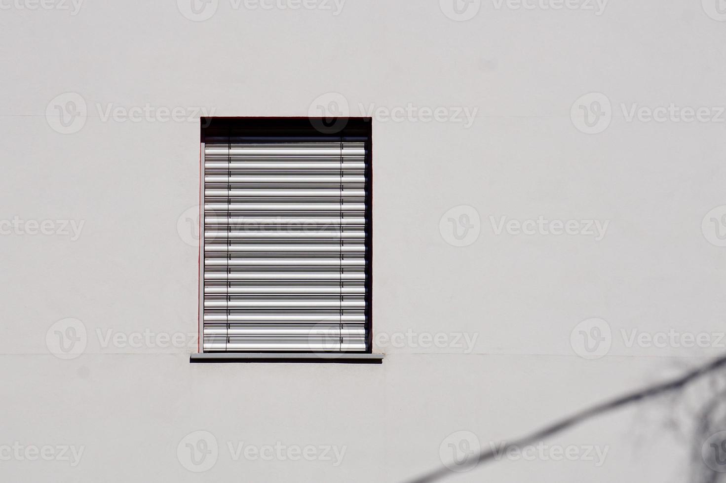 window on the white facade of the house photo