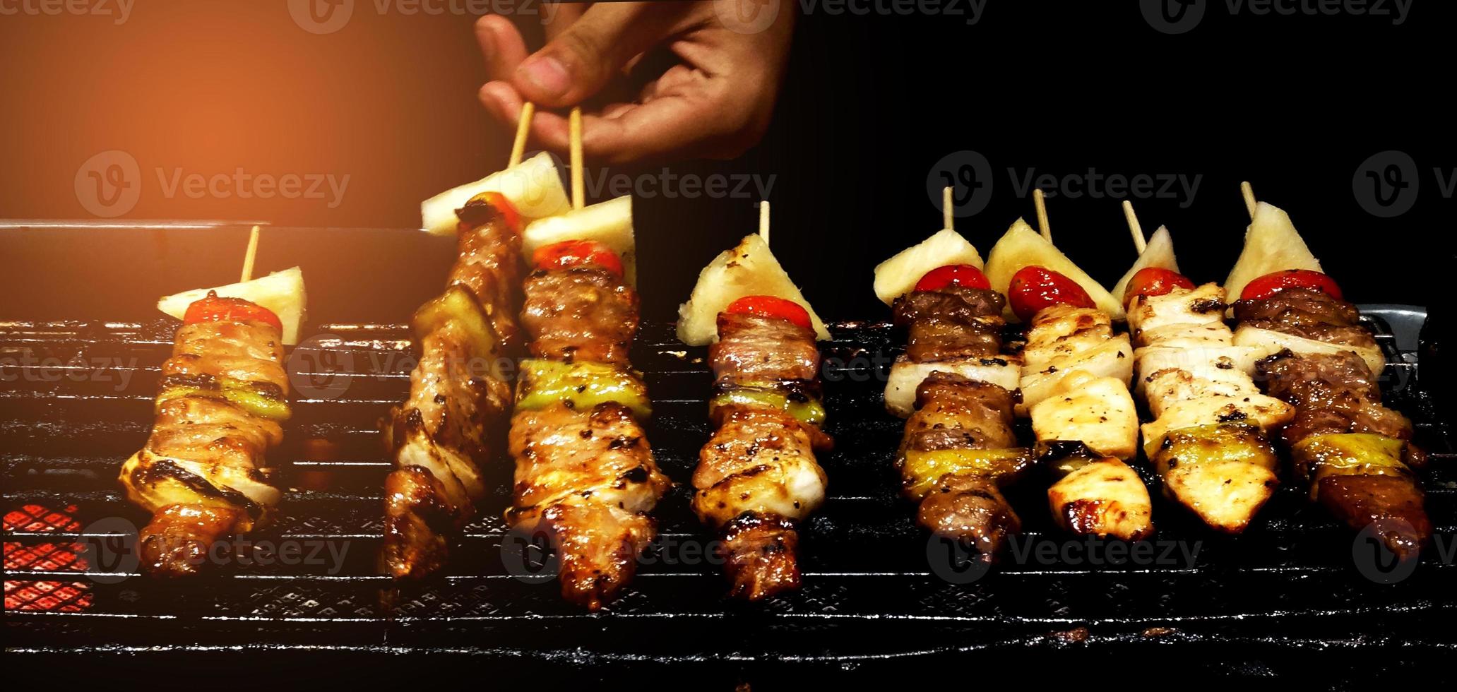 The chef is grilling the barbecue on the stove photo