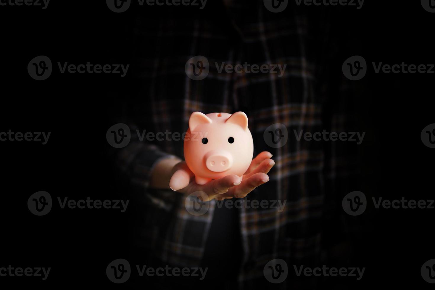 Piggy bank on woman s hand Saving money concept photo