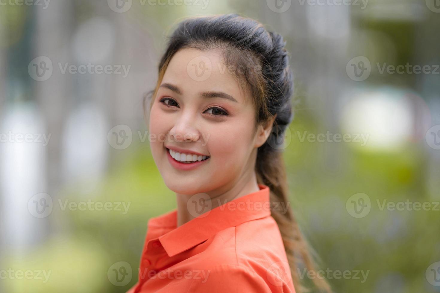 Outdoors portrait of Happy young woman photo