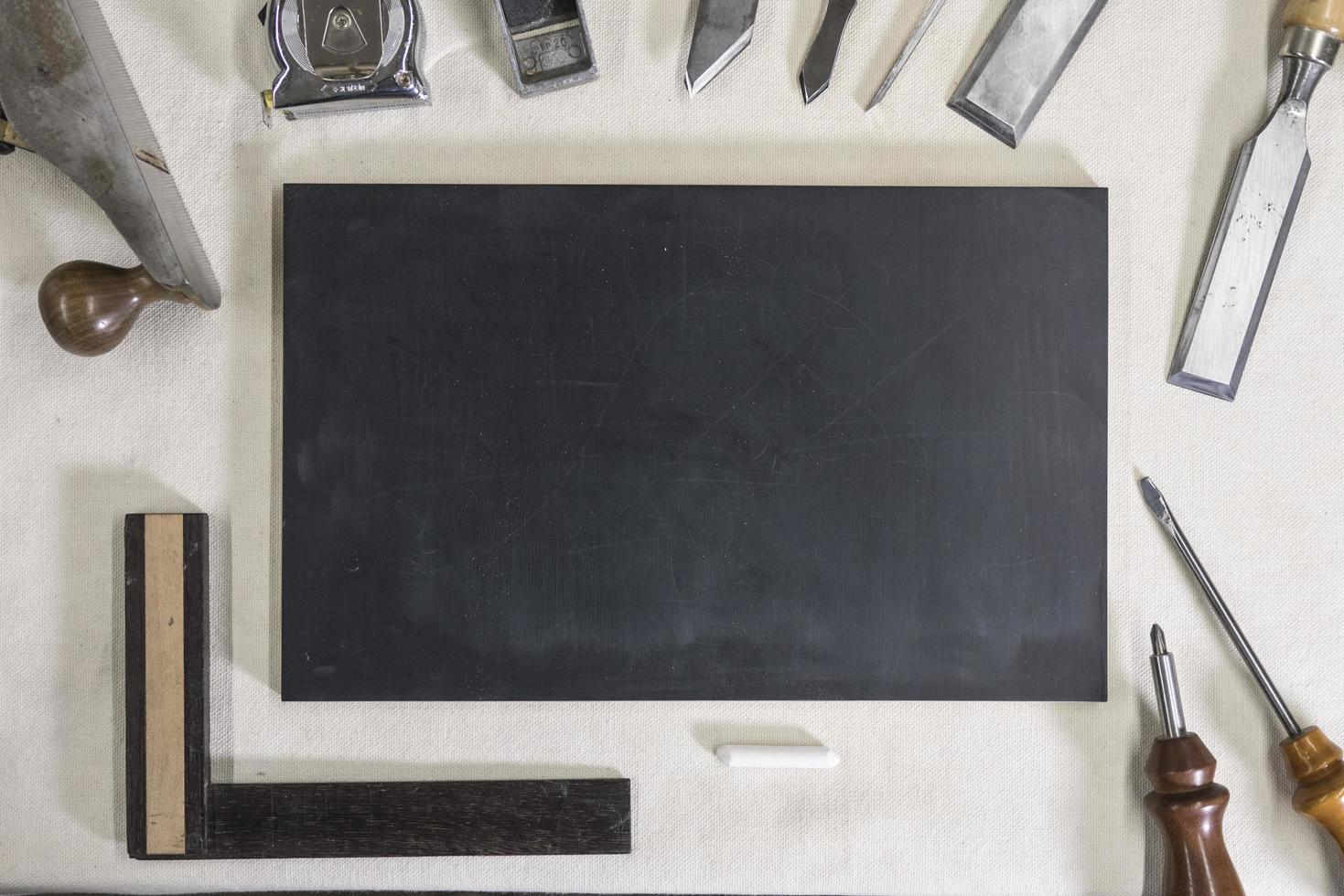 blackboard for chalk on a workbench and carpentry tools photo