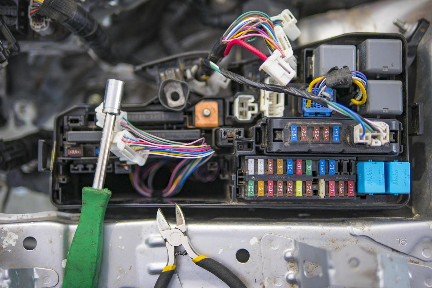 car electrician repairs car tester and fuses and nippers photo