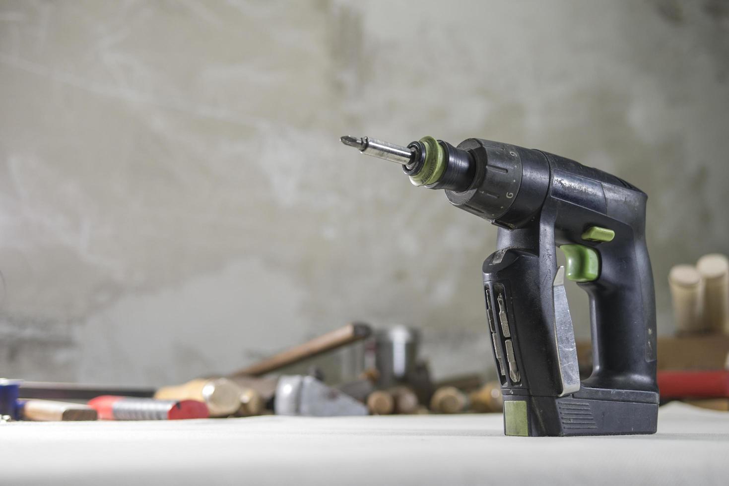 drill screwdriver in the carpentry mater on the workbench photo