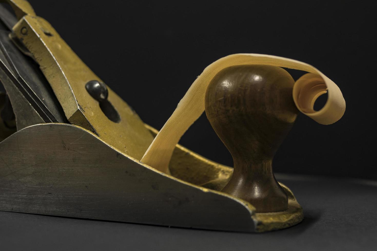 hand plane on a black background shavings photo