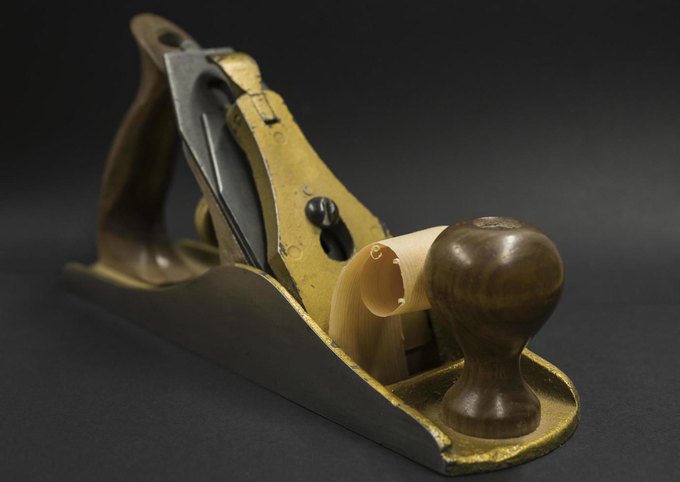 hand plane on a black background shavings photo