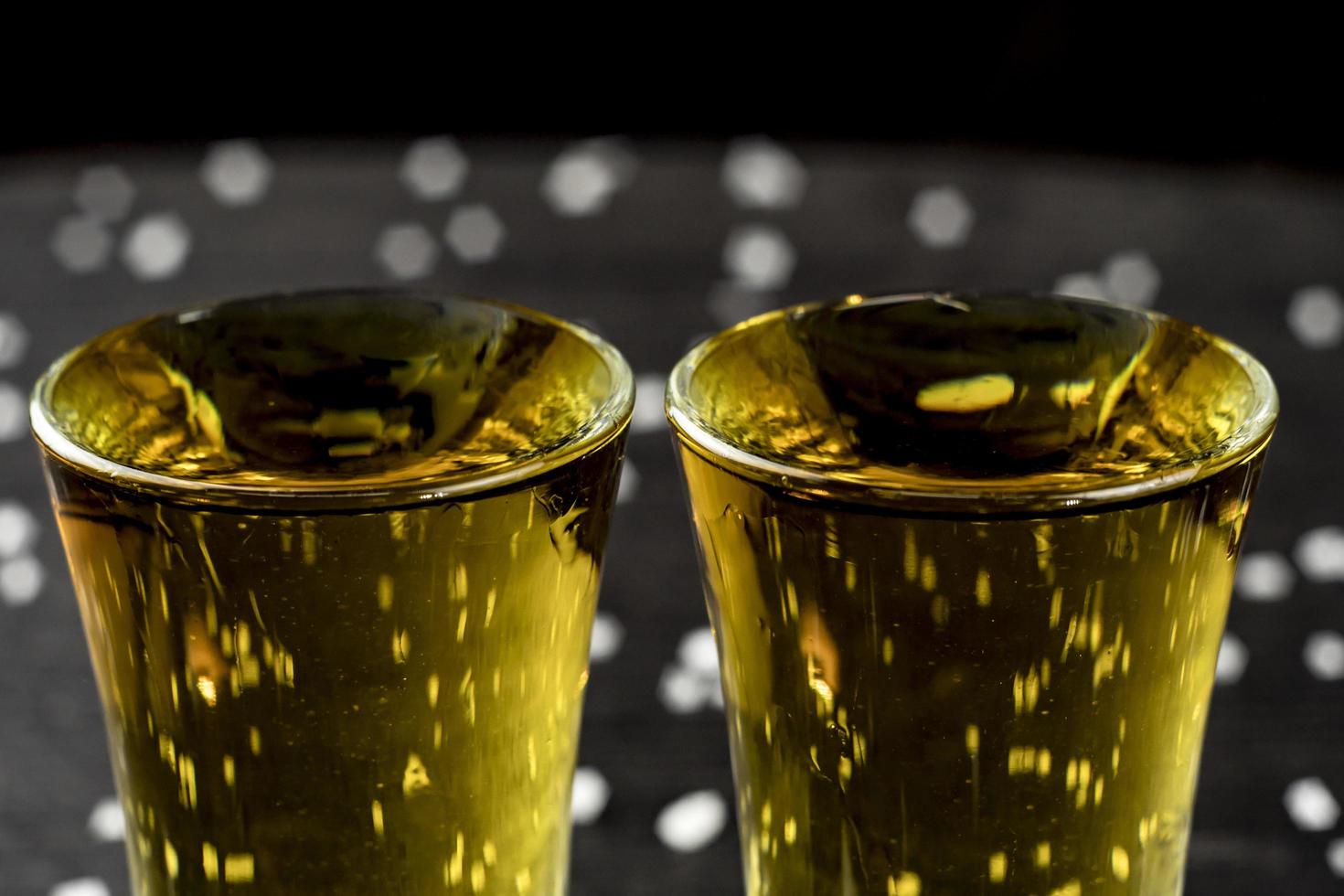 two glasses of tequila with lime and salt photo