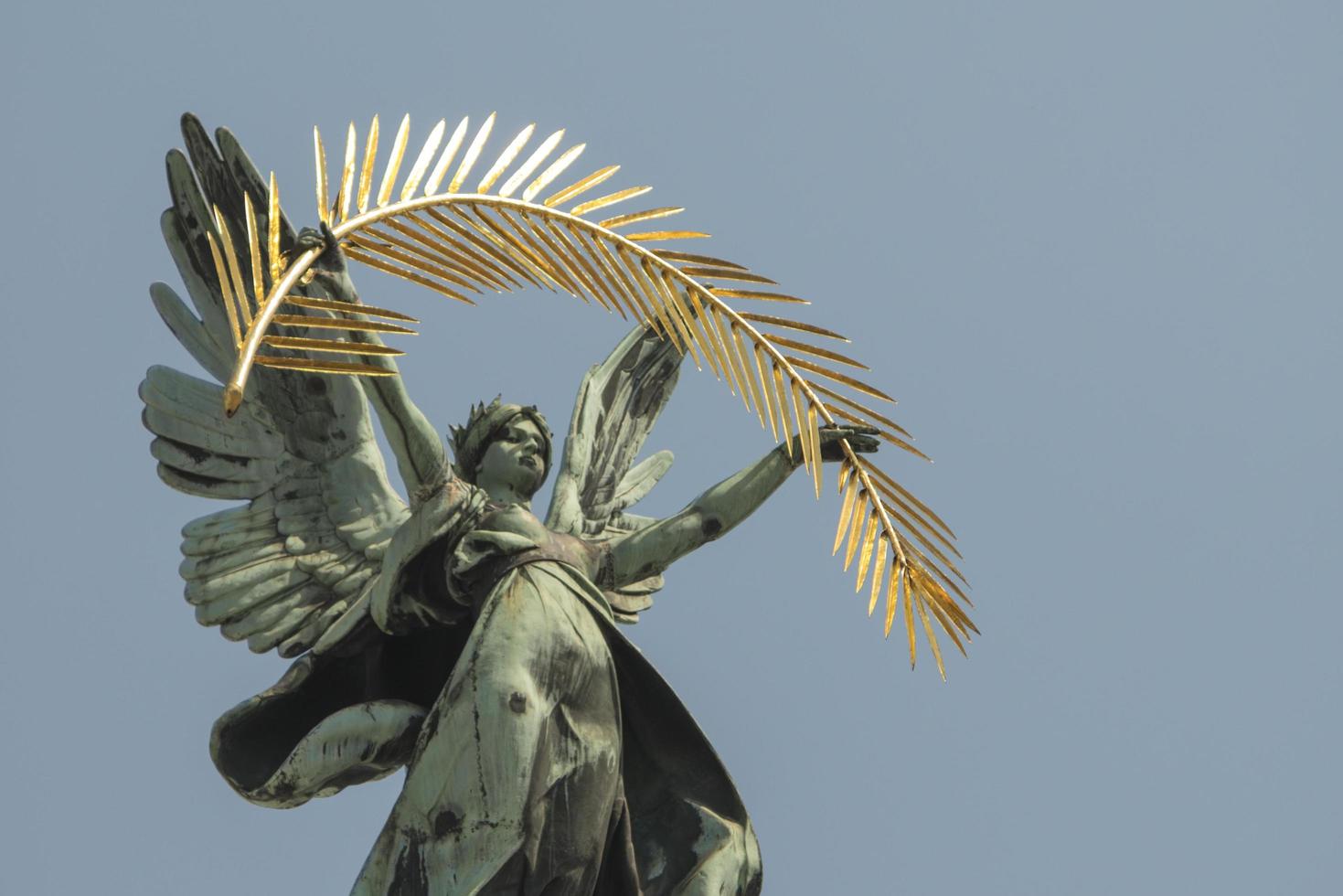 bronze sculpture genius with wings on the roof of the opera house in Lvov photo