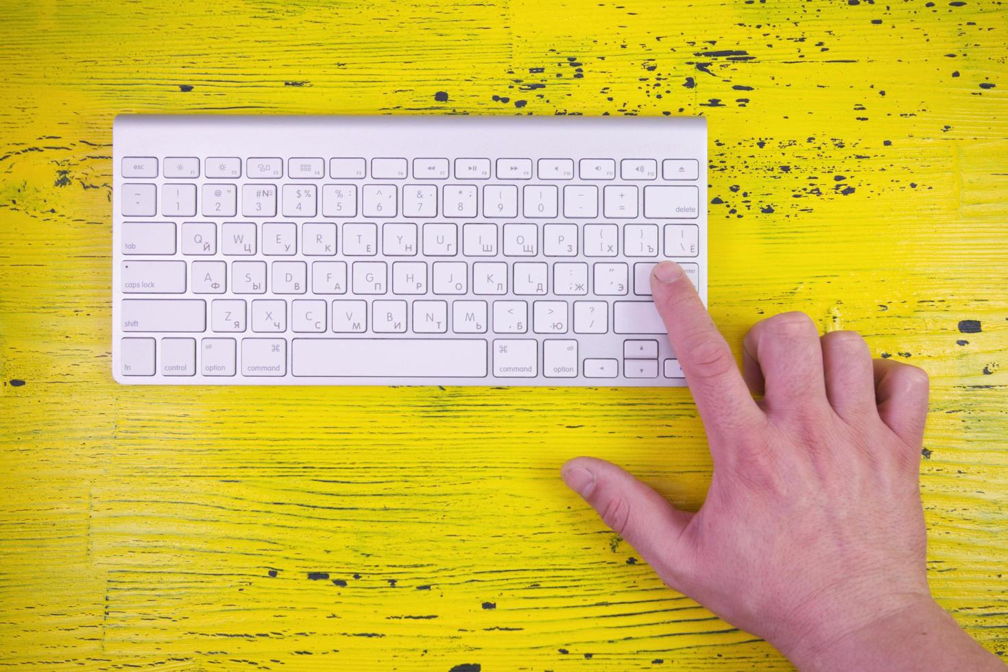 click enter on keyboard on a yellow background photo