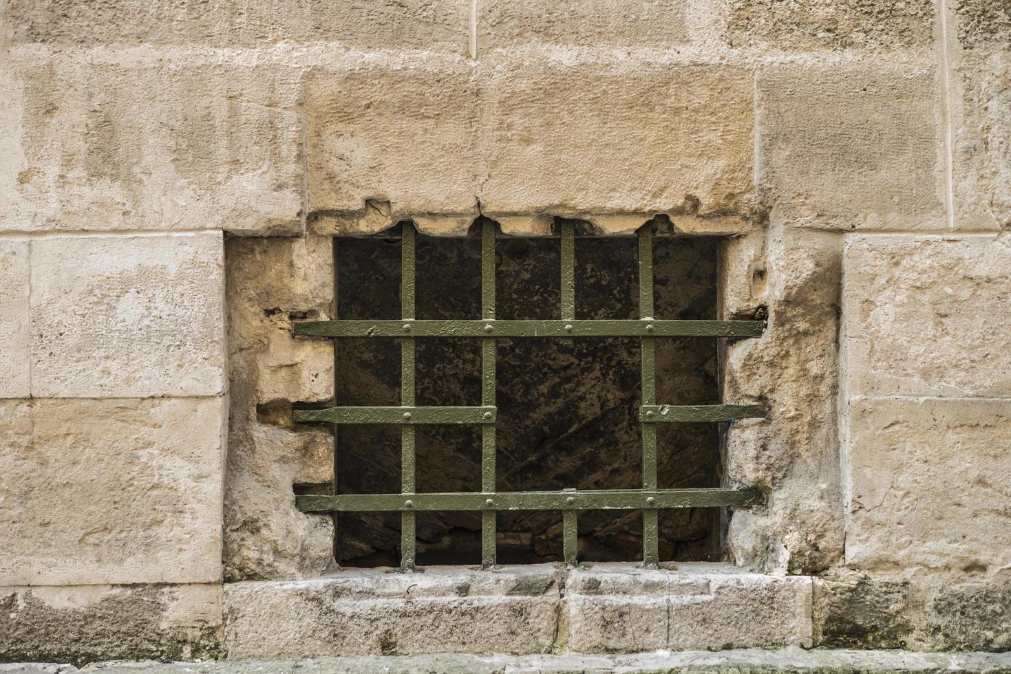 lattice with a hole in the window in the old town photo