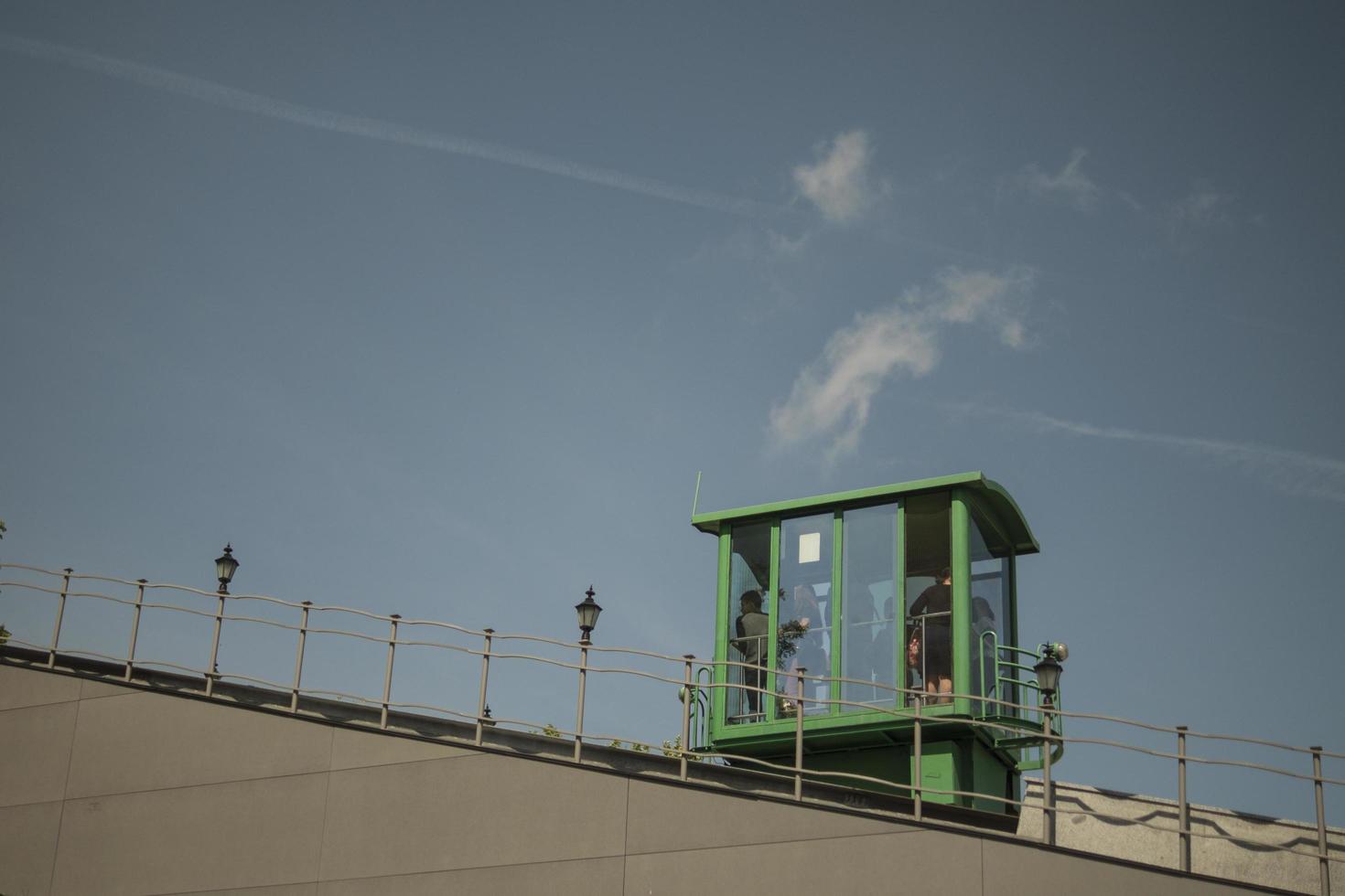 green funicular with tourists goes up photo