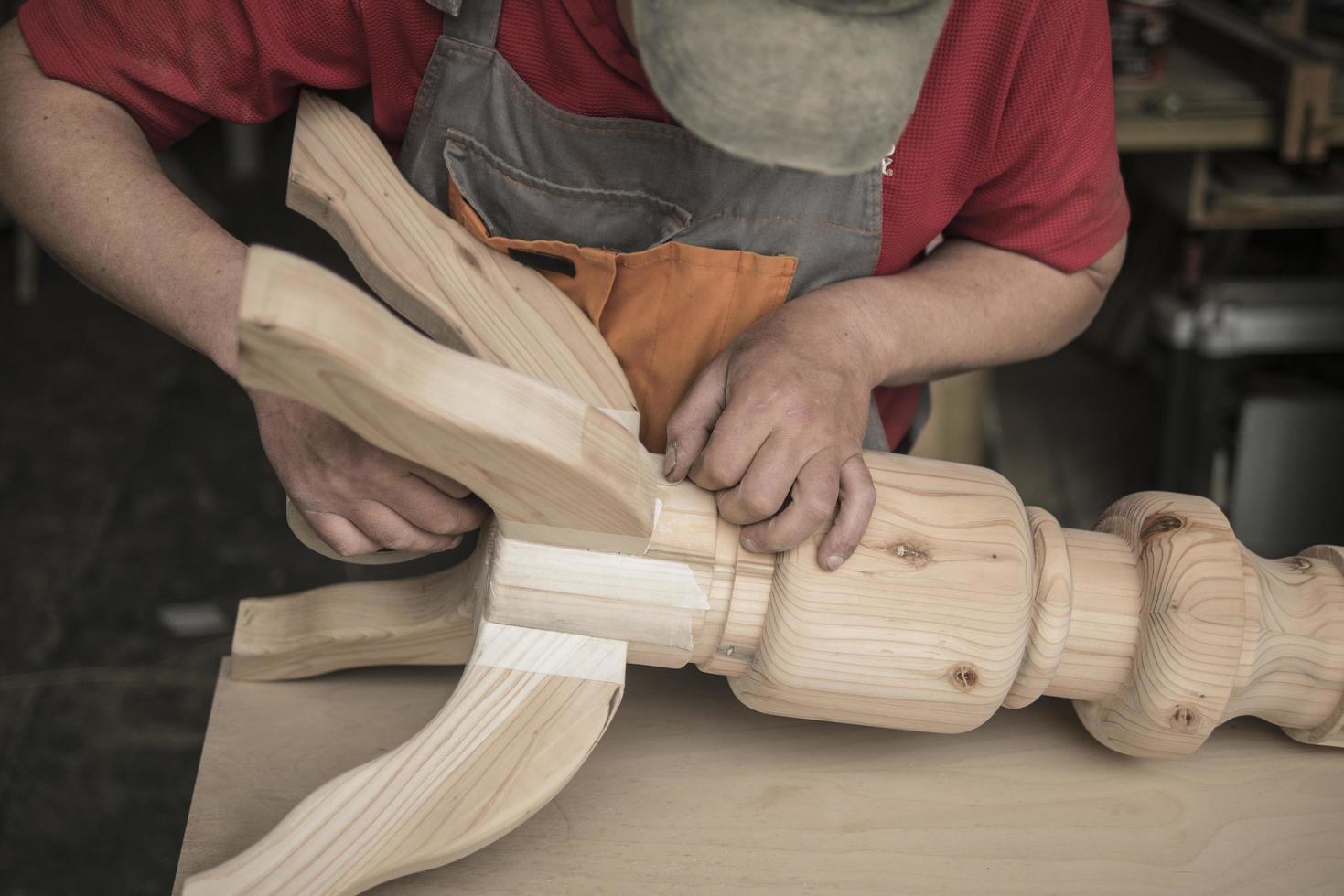 carpenter makes a table with carved legs photo