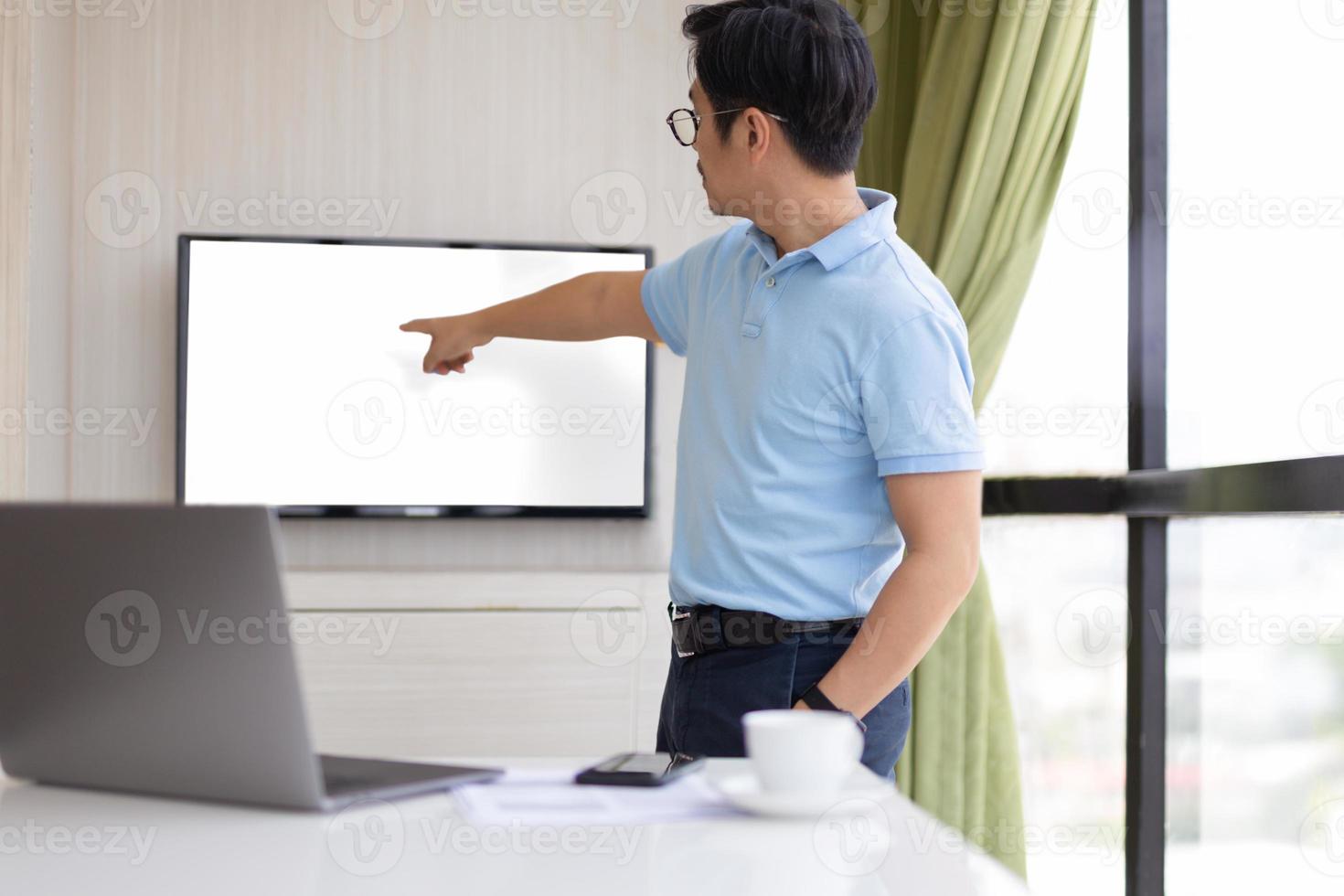 Businessman presention in conference room with hand pointing at screen photo