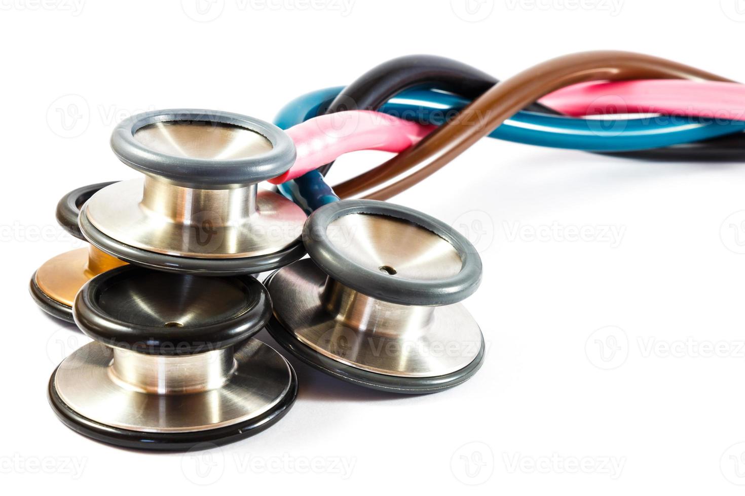 twist colorful stethoscopes on white background  isolated  and blank area at right side photo