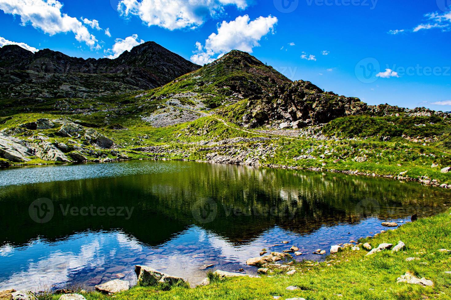 Clouds above mountains and lake photo