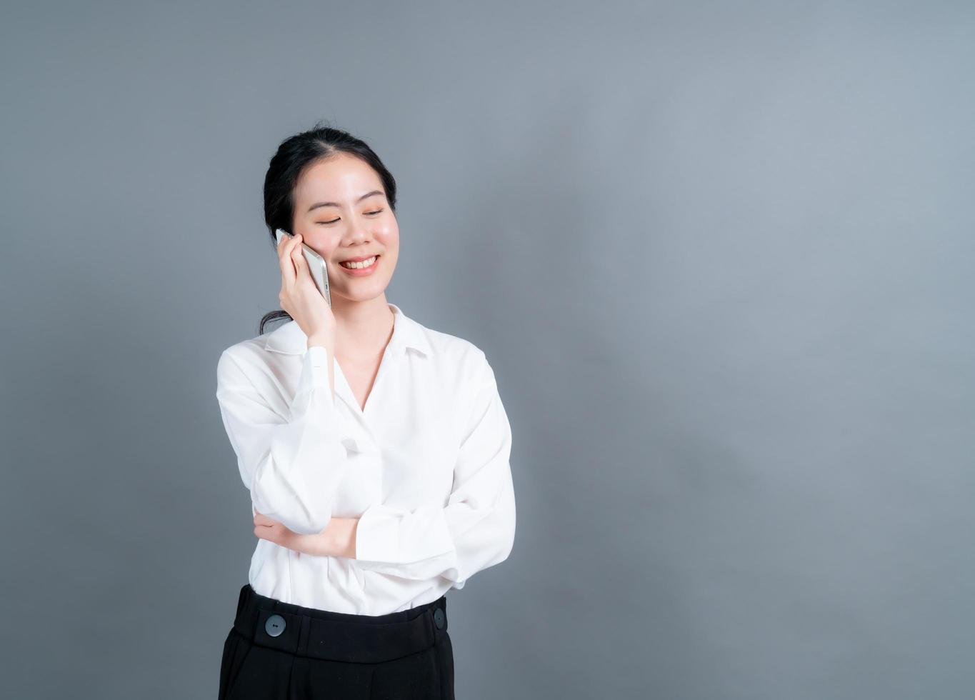 Asian woman using mobile phone talking business photo