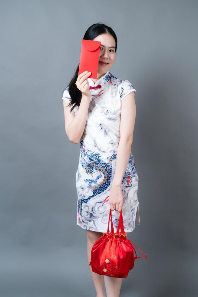 Asian woman wear Chinese traditional dress with red envelope or red packet photo