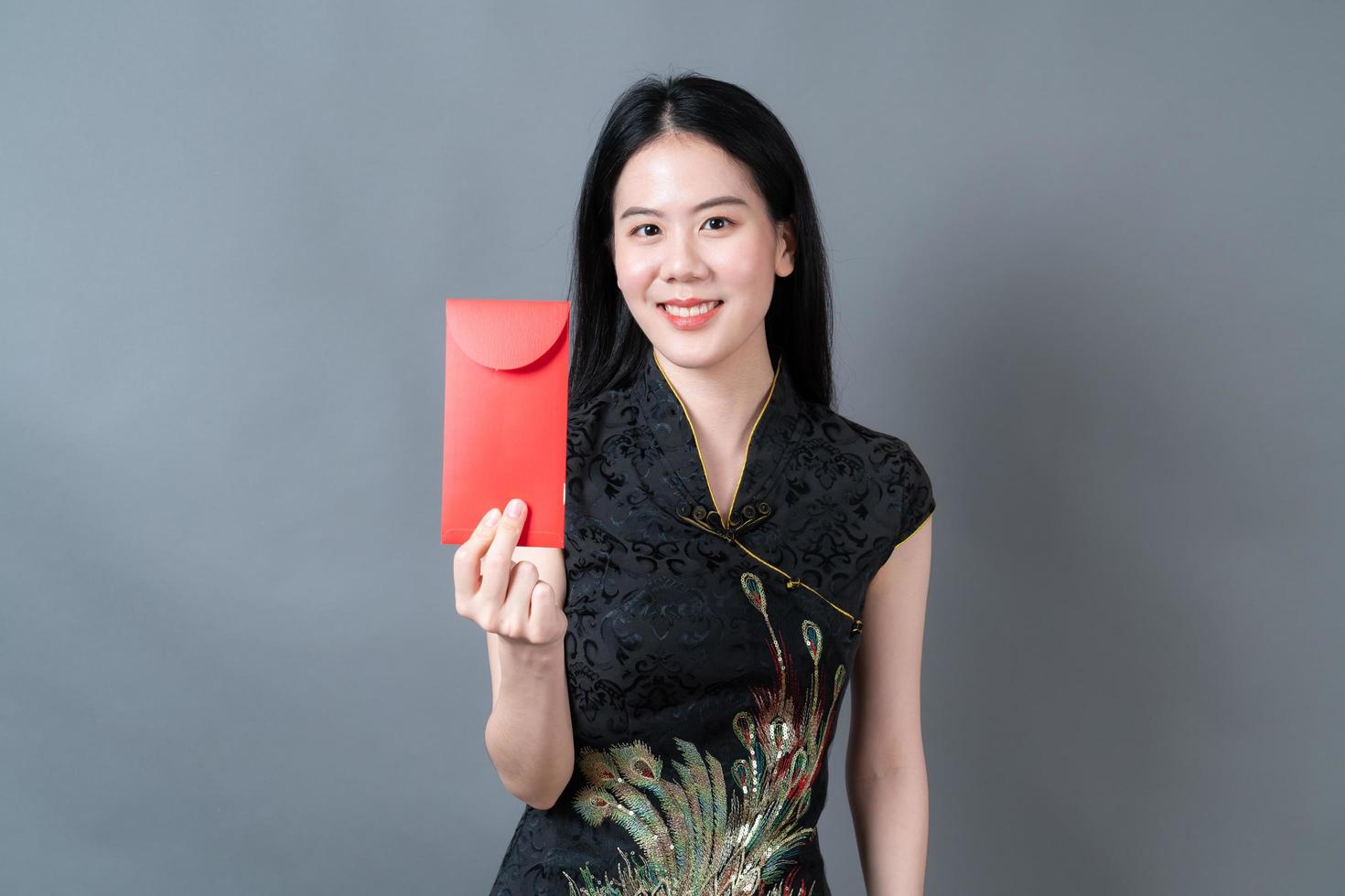 Asian woman wear Chinese traditional dress with red envelope or red packet photo