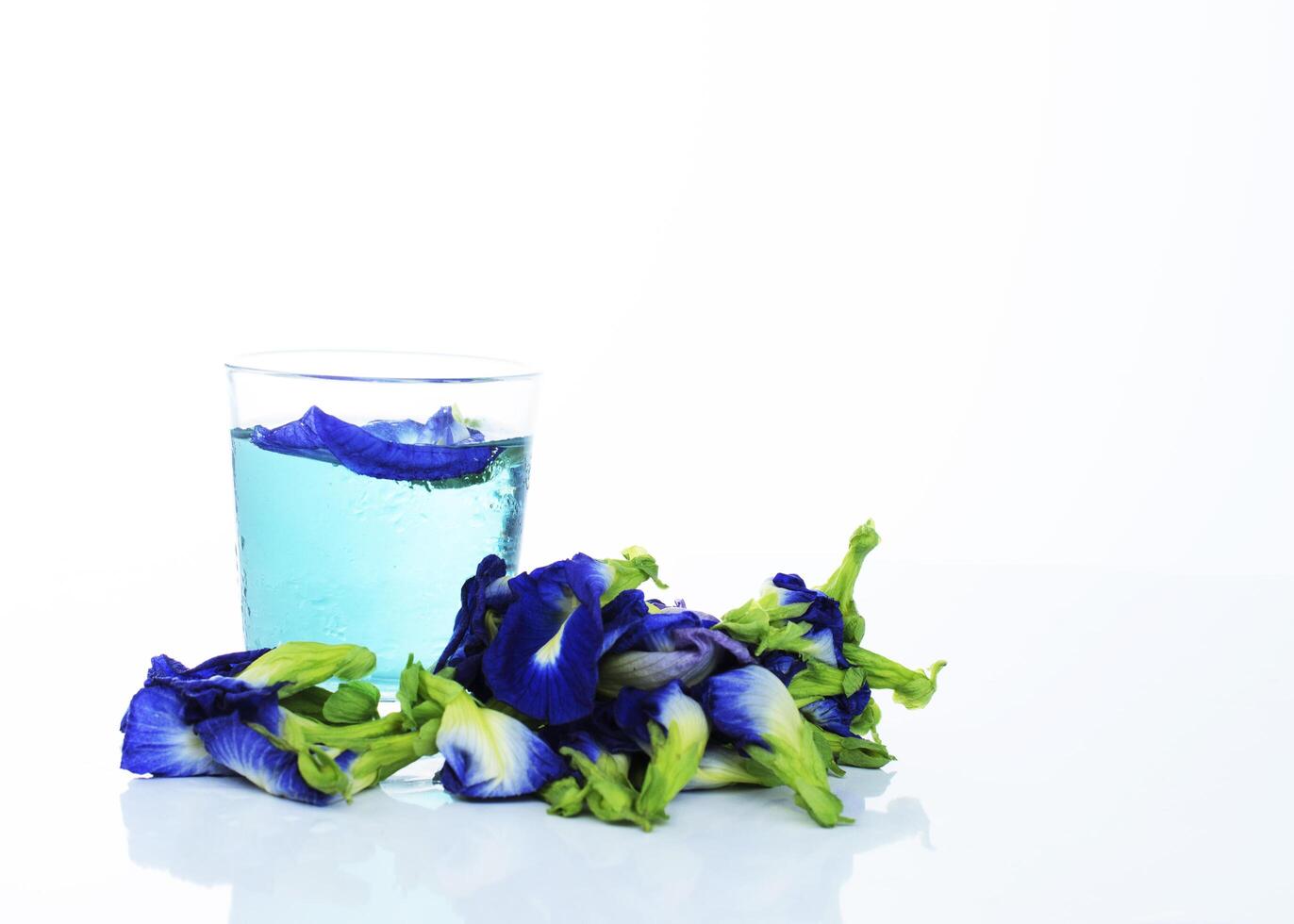 Blue drink with butterfly pea herbal on white background photo