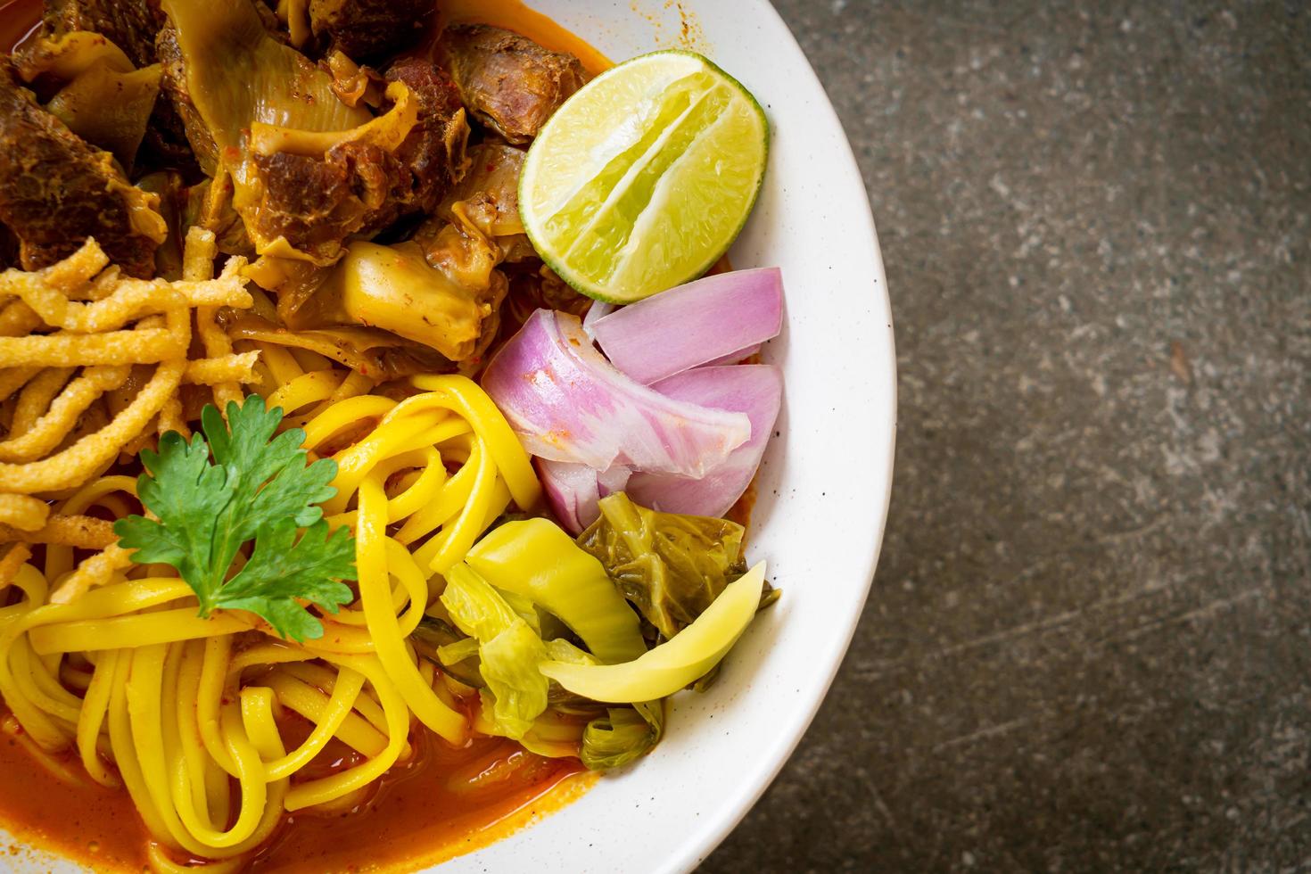 Northern Thai noodle curry soup with braised pork photo