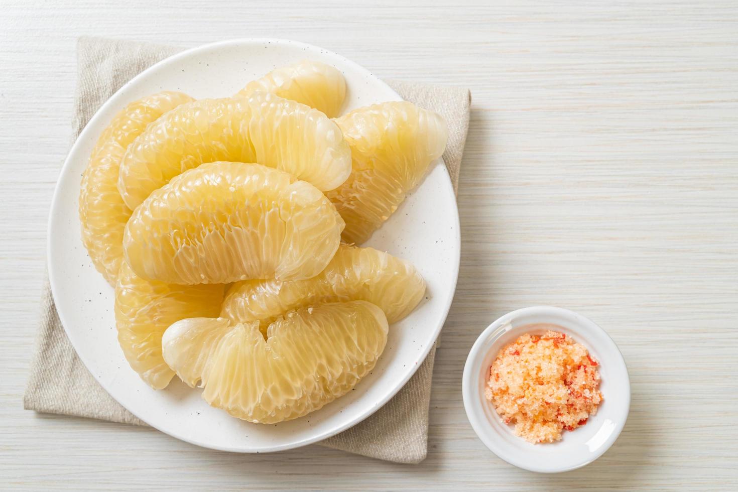 Fresh peeled pomelo grapefruit or shaddock photo