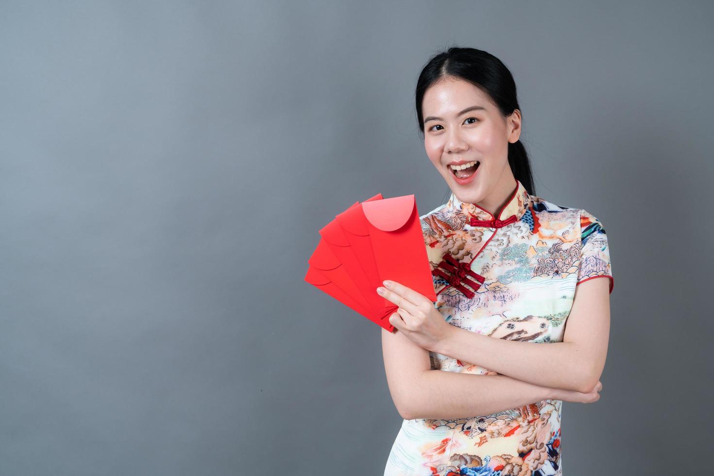 Asian woman wear Chinese traditional dress with red envelope or red packet photo