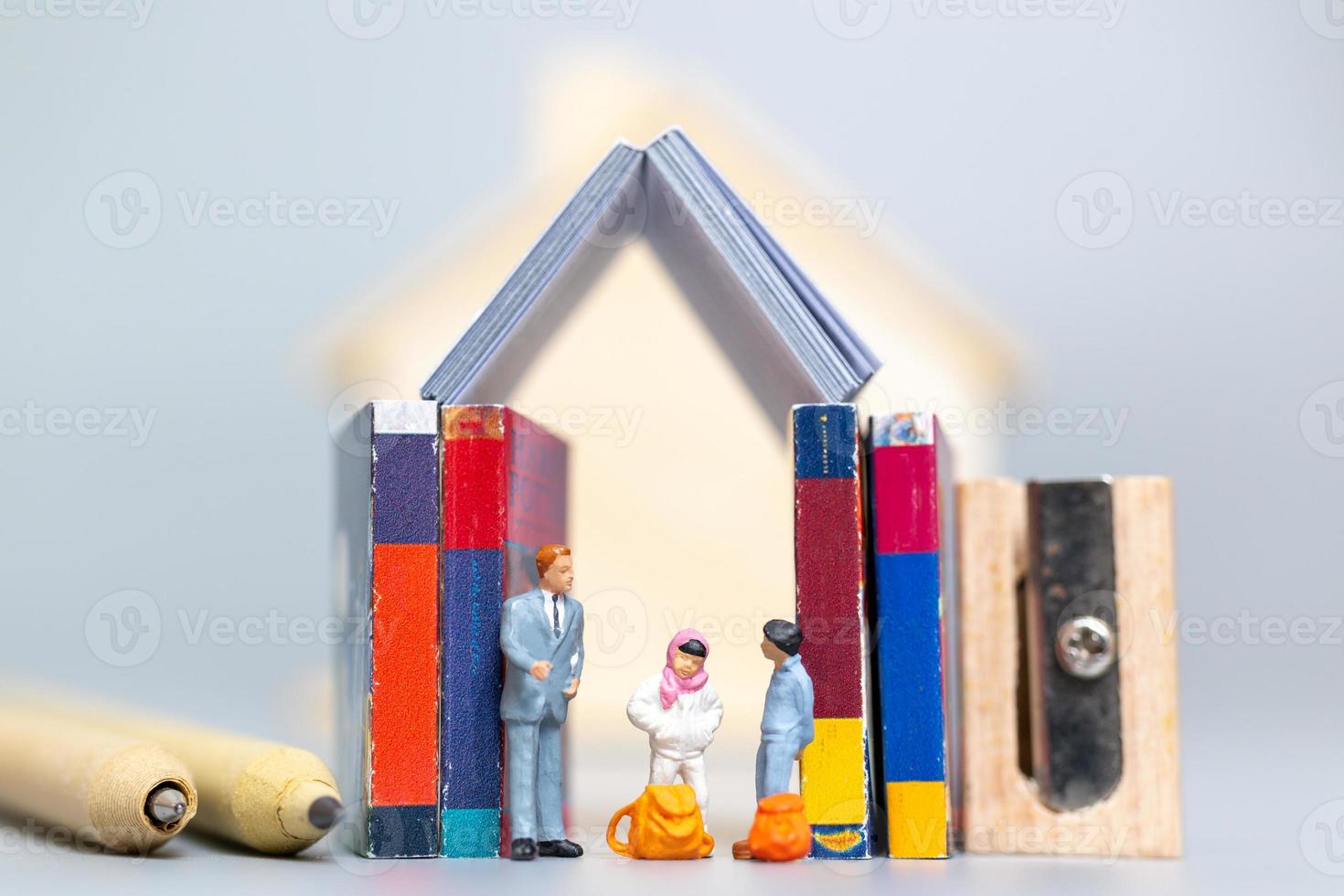 Miniature people, student and teacher with stationery tools, back to school concept photo