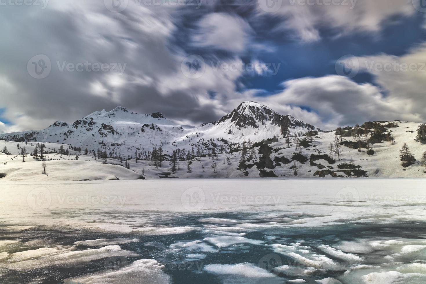 Ice blocks in alpine lake during thaw photo