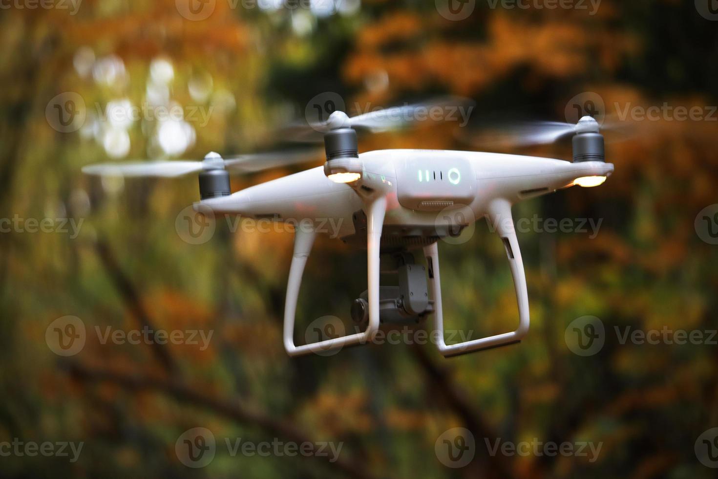 Flying drone in autumn yellow forest environment photo