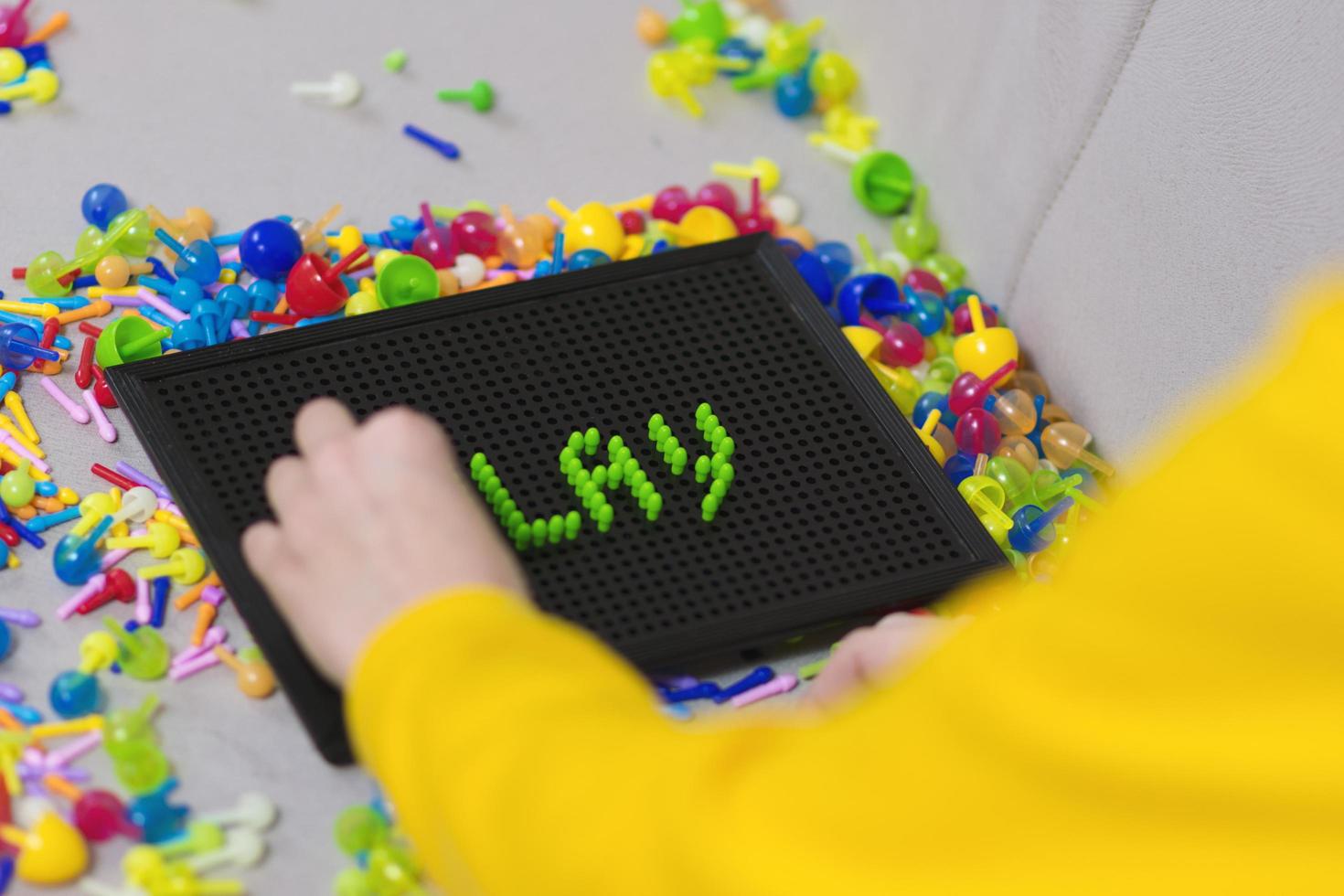 Kid playing pinning board game photo