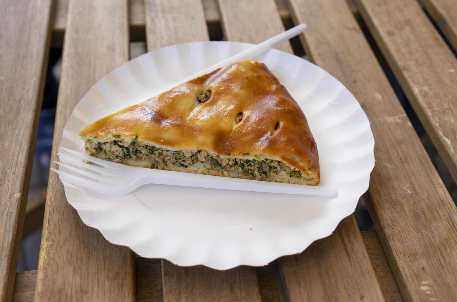 Fish pie with disposable dishes on a wooden table photo