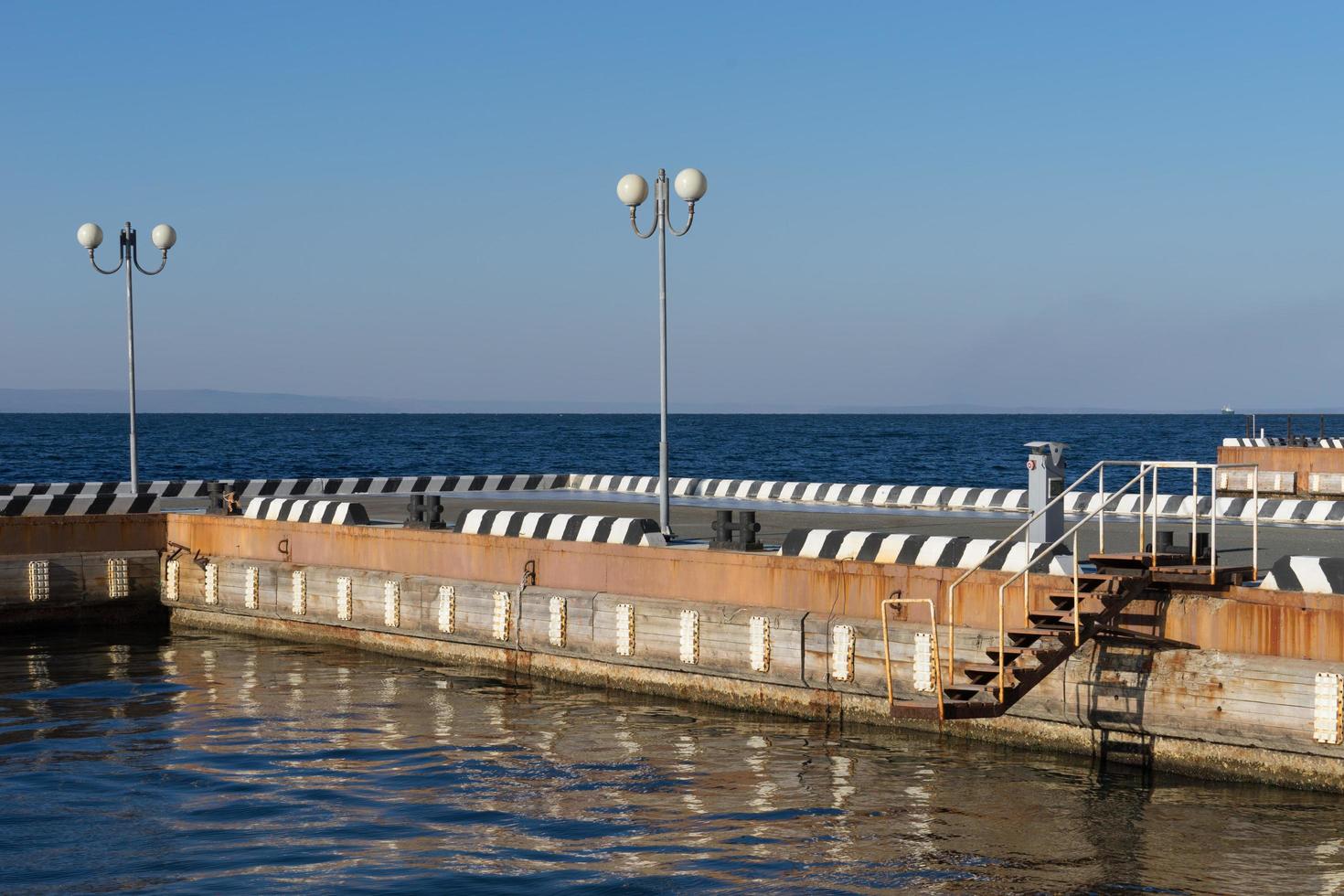 Seascape with pier and beautiful lanterns in the sky photo