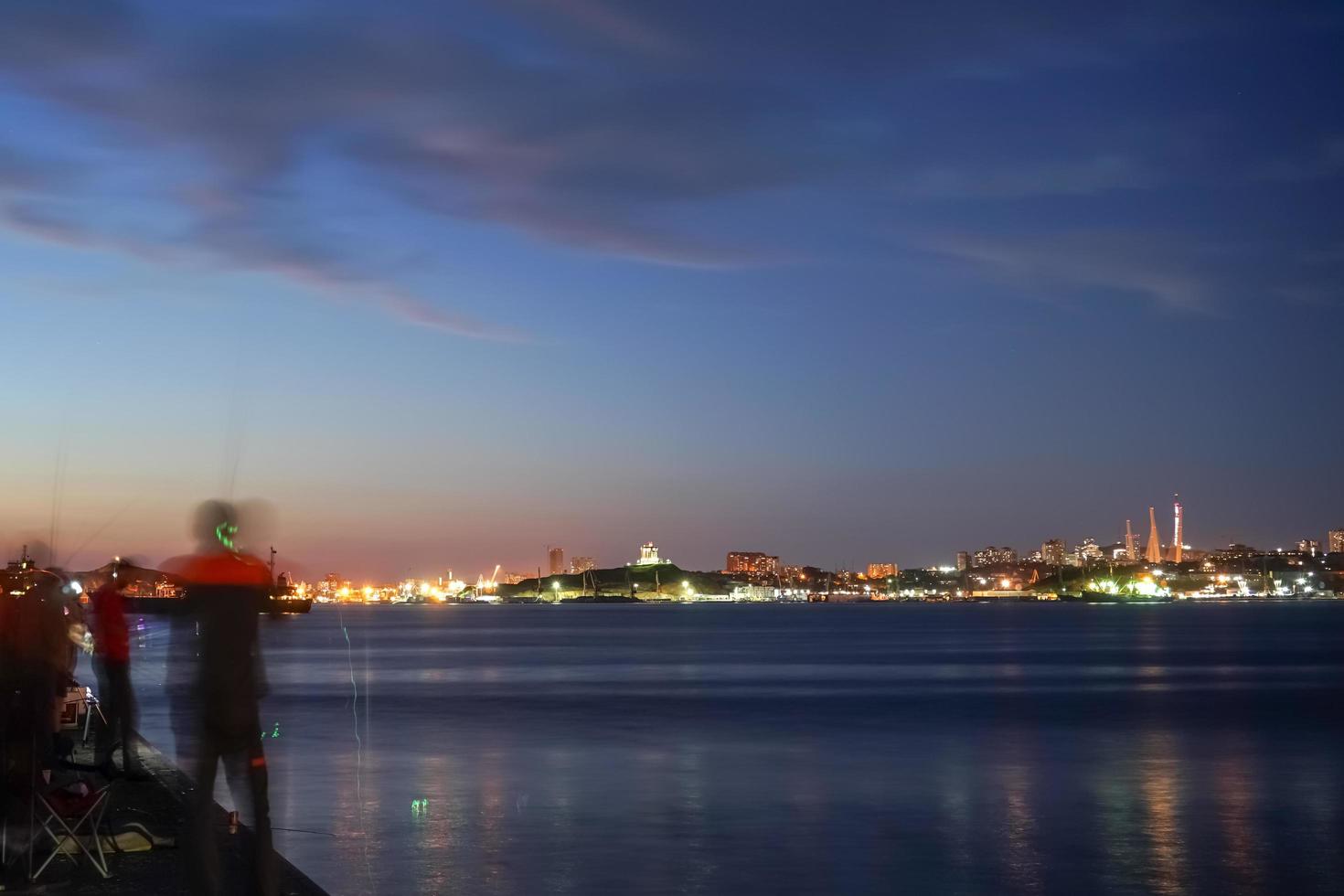 Seascape with fishermen in the blue hour photo