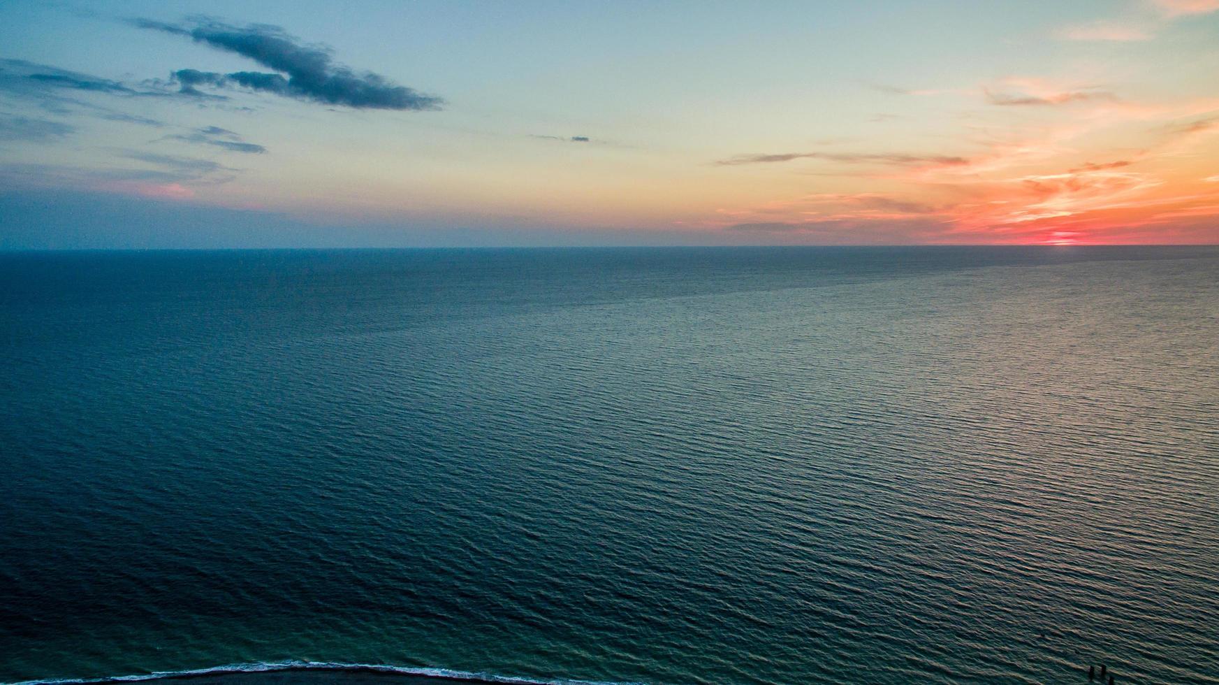 Sunset over a calm sea from the height of bird flight photo