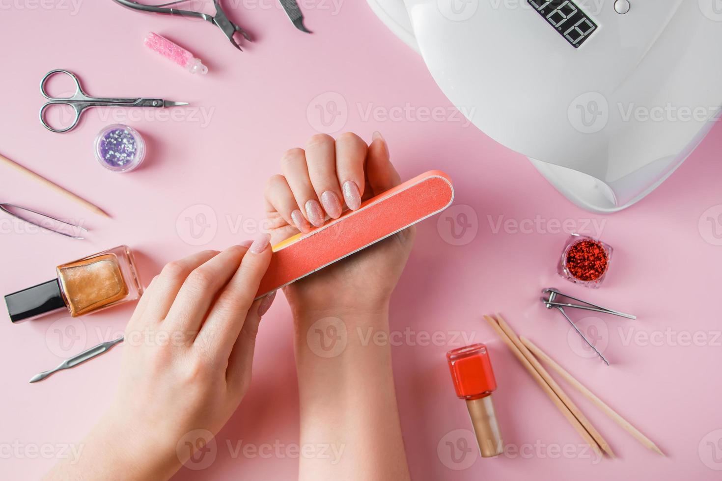 Woman does a manicure at home photo