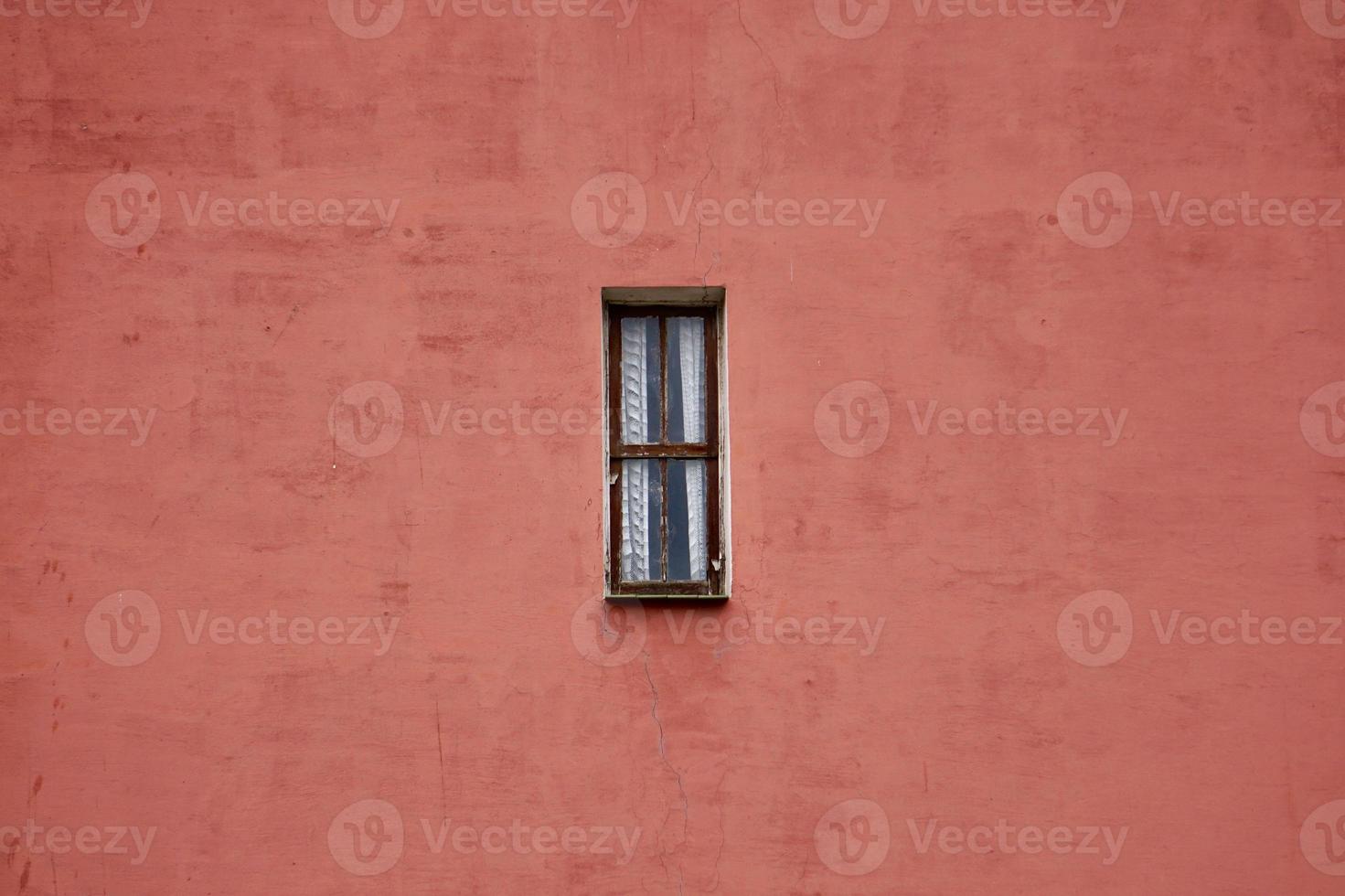 window on the red facade of the house photo