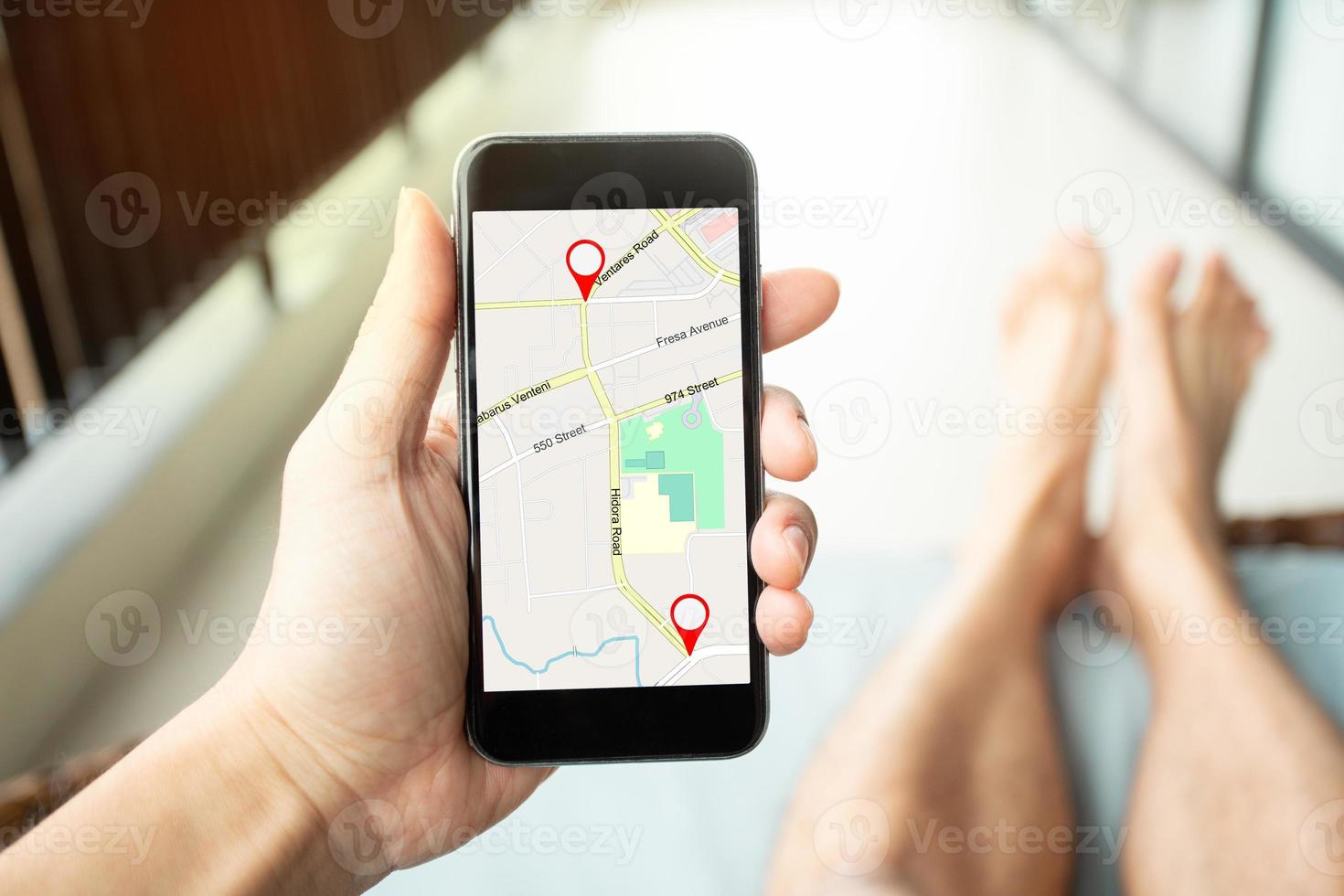 Mano de hombre sosteniendo un teléfono inteligente con mapa gps al destino de la ruta foto