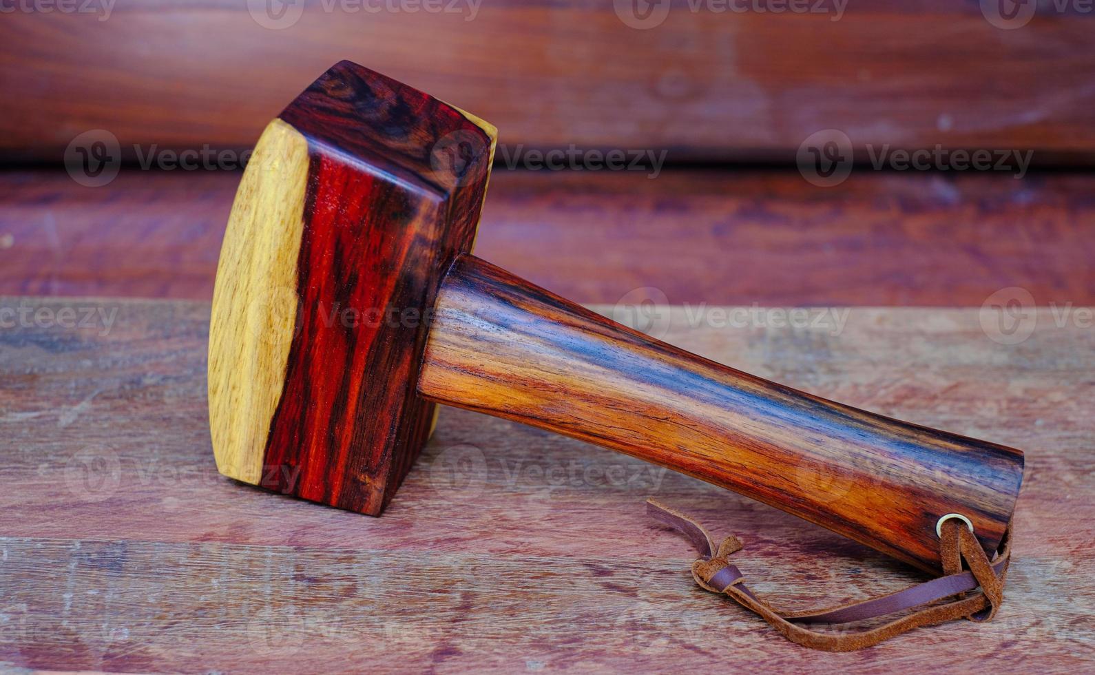 mallet hammer wood made of rosewood and tool handmade of Thailand for use by a carpenter in the workshop on the old workbench photo