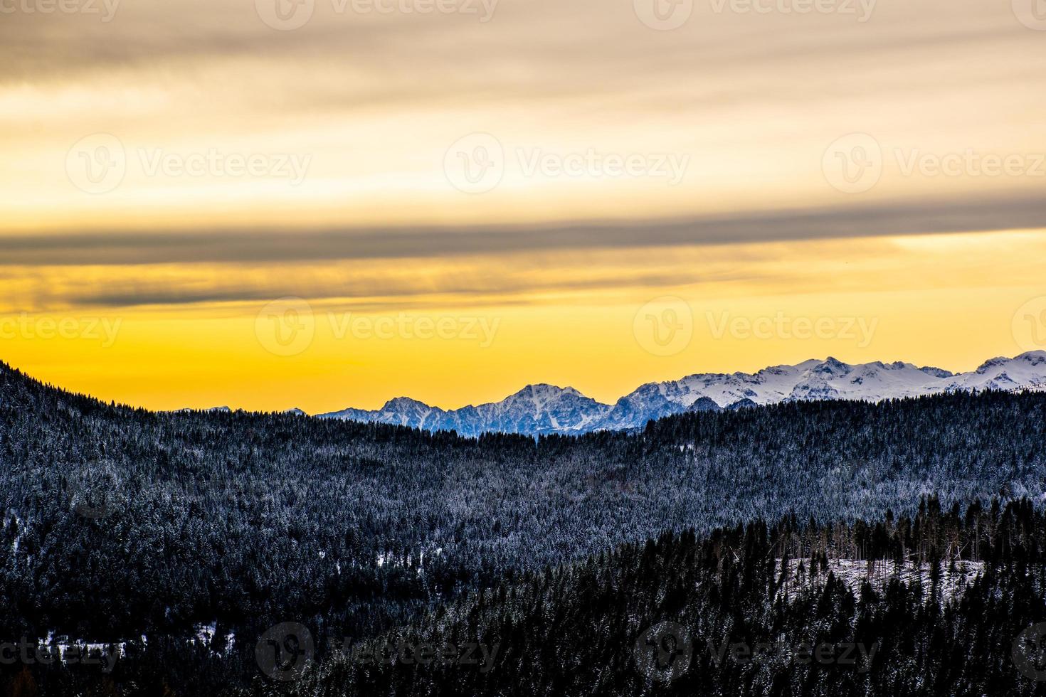 Golden sunrise above mountains photo