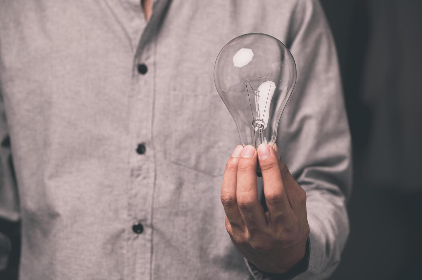 A man holding a light bulb photo