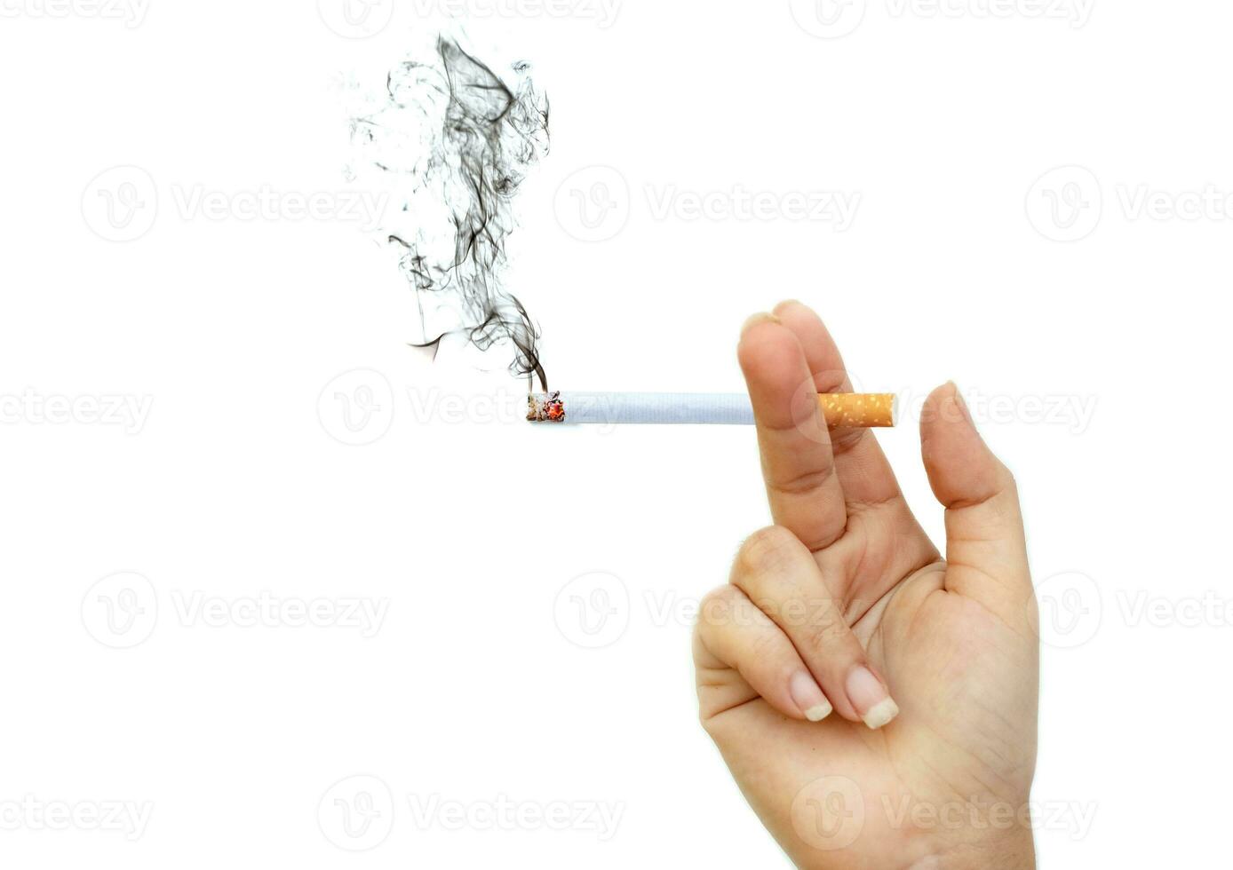 Image of cigarette burns with smoke in lady is hand photo