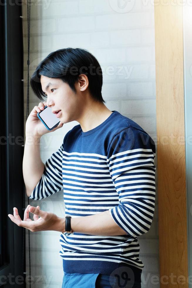 Businessman uses mobile phone to talk on the phone with friends photo