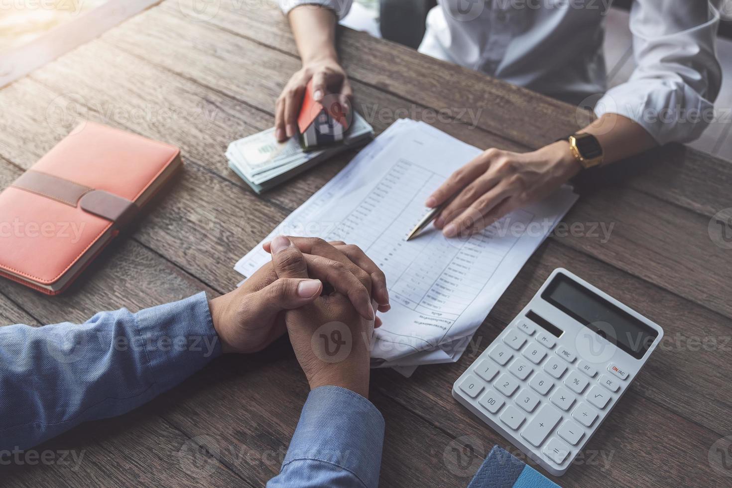 Real estate agent or bank officer describes the loan interest to the customer photo