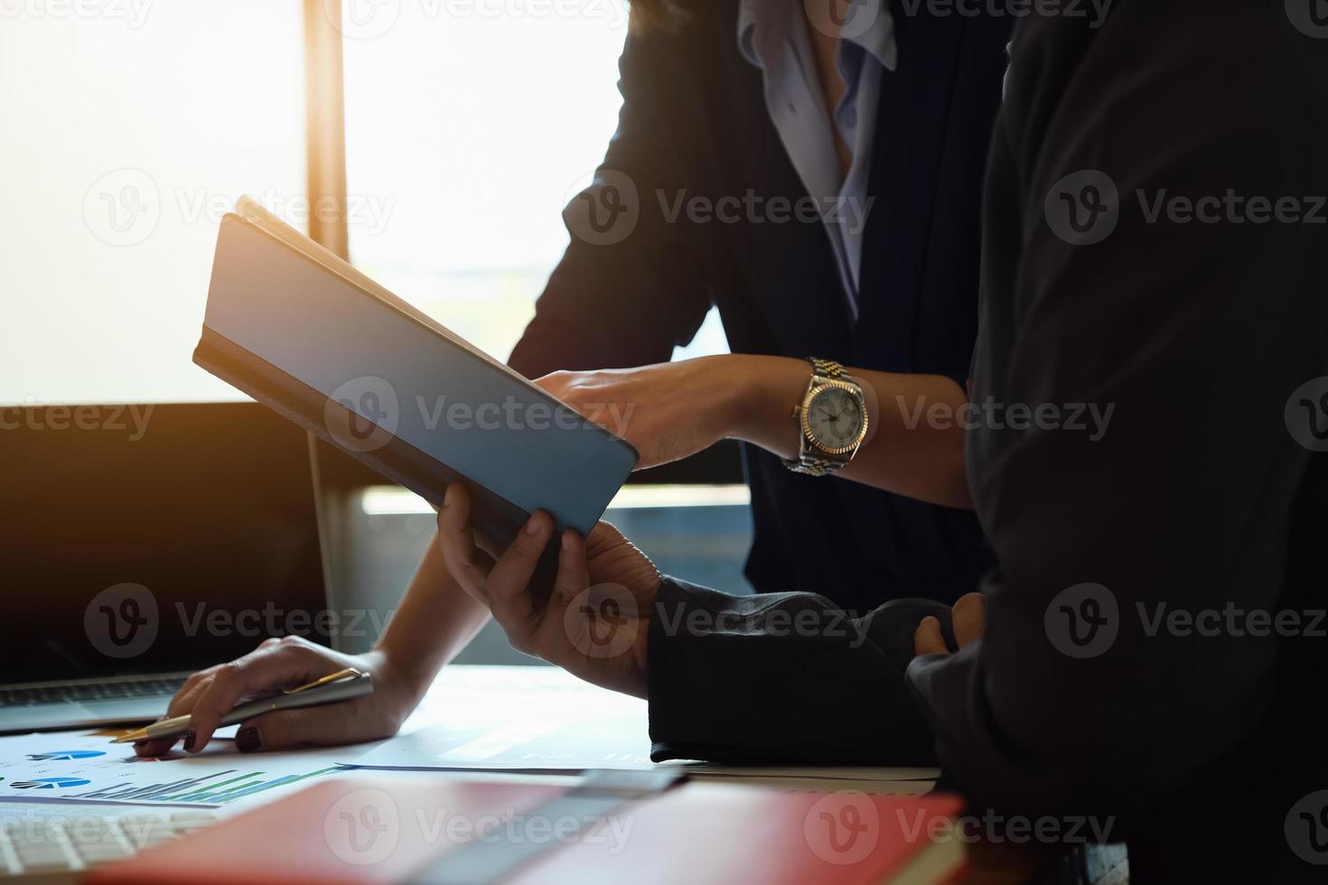 Business consultants using notebook photo