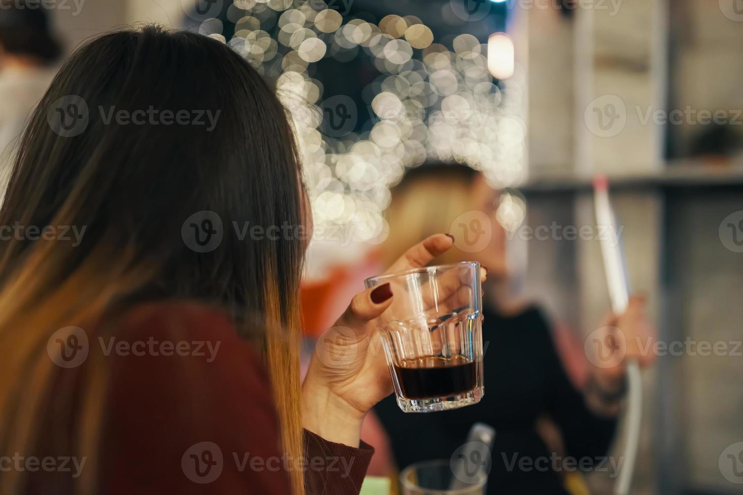 Two women relax in lounge bar photo