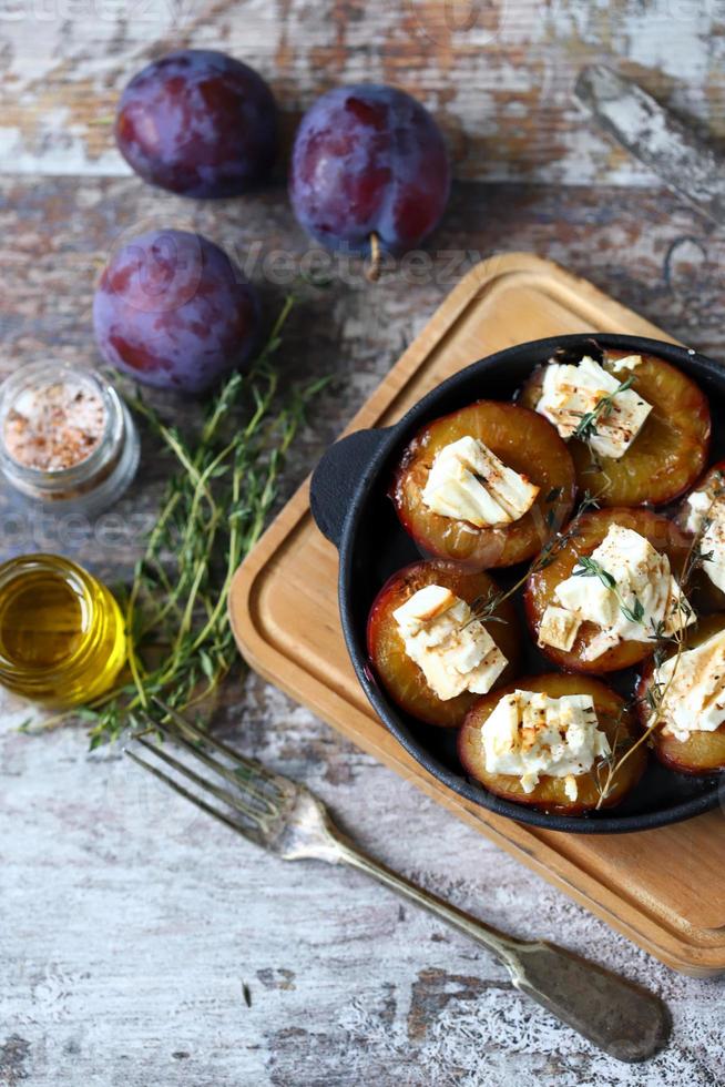 Baked plums with white cheese photo