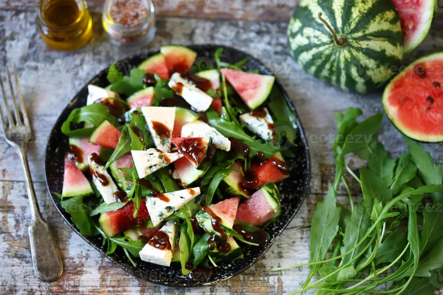 Watermelon salad with arugula and gorgonzola cheese photo