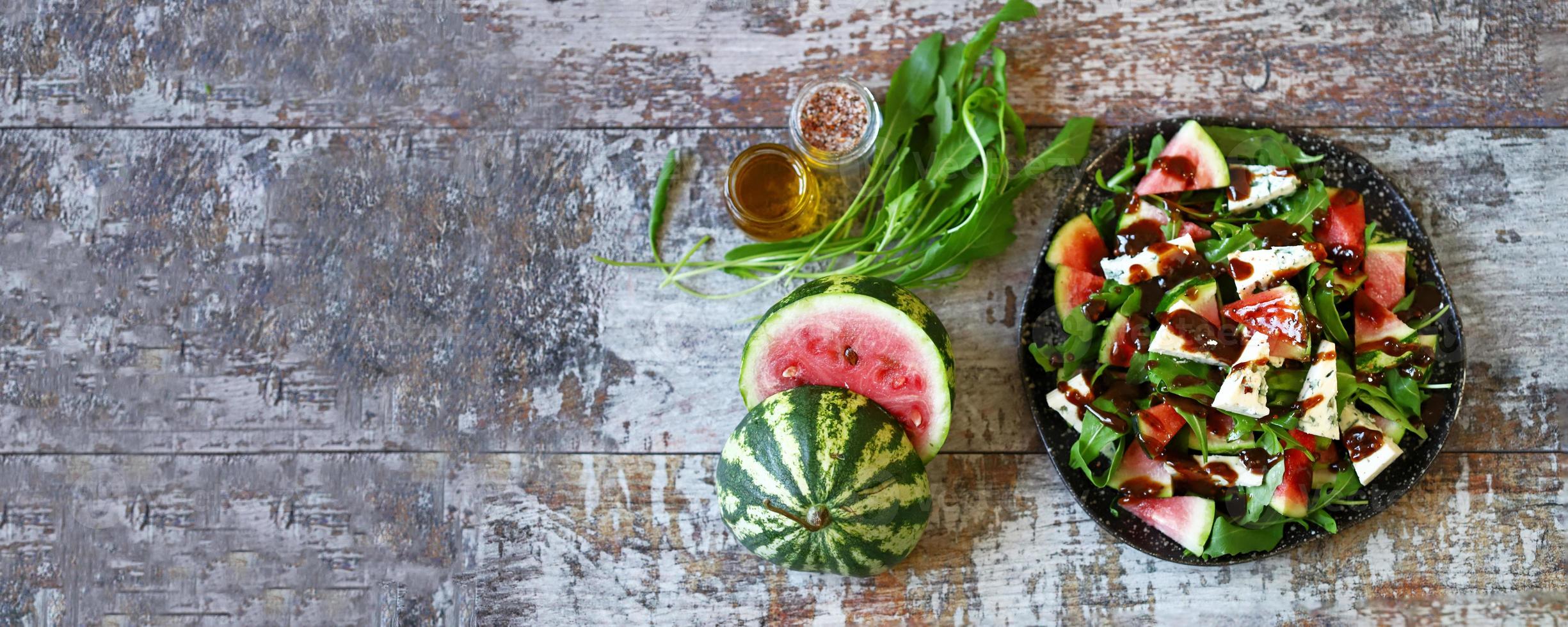 Watermelon salad with arugula and gorgonzola cheese photo